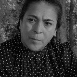 Inés Murillo — Client at Roadside Stand (uncredited)