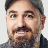 Brian Quinn — Man Holding Mooby Figurine in Airport (uncredited)