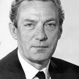 Peter Finch — British agent (uncredited)