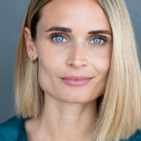 Malin Barr — Swedish Newscaster (uncredited)