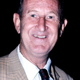 Doodles Weaver — Fisherman Helping with Rental Boat