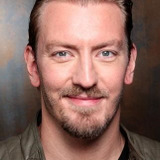 Darrel Cherney — News Anchor (uncredited)