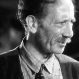 Egon Brecher — Hotel Desk Clerk (uncredited)