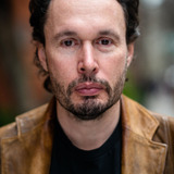 Chris Kerson — Kimmie Belzer's Desk Mate (uncredited)