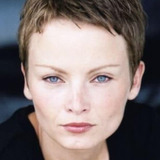 Ulla Friis — Danish News Anchor (uncredited)