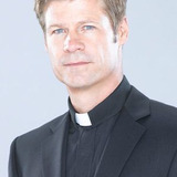 Joel Gretsch — Father Jack Lowery