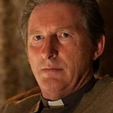 Adrian Dunbar — Father Peter Flaherty