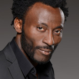 Babs Olusanmokun — Dr. Joseph M'Benga